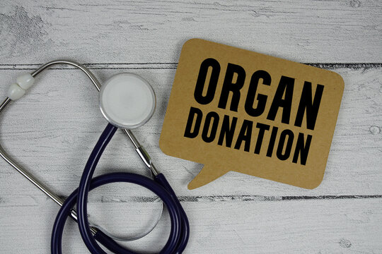 Organ Donation text with Stethoscope on wooden background