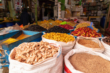 Colorful Moroccan Spice Market With Dried Herbs, Roots, Olives and Exotic Seasonings in Open Sacks and Bowls – Traditional Souk Scene