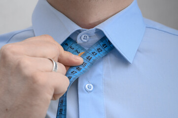 Tailor-made elegant shirt, man measures neck circumference, collar size