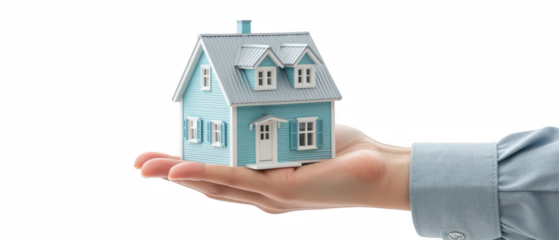 Hand holds small model house, showcasing charming blue exterior with white accents. This conveys sense of care and ownership