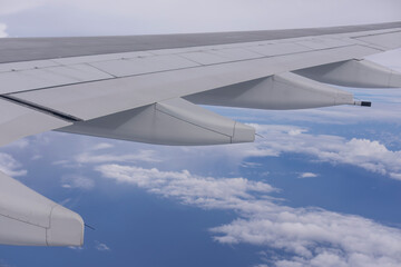 Jet Airplane Wing Seen From Inside Cabin – Aerial Perspective of Sky and Clouds During...