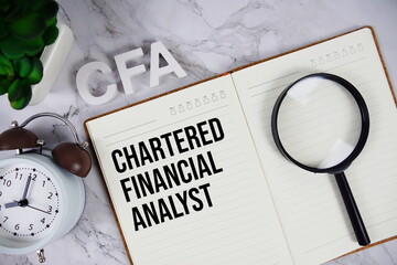 CFA - Chartered Financial Analyst acronym on notepad, Business concept background