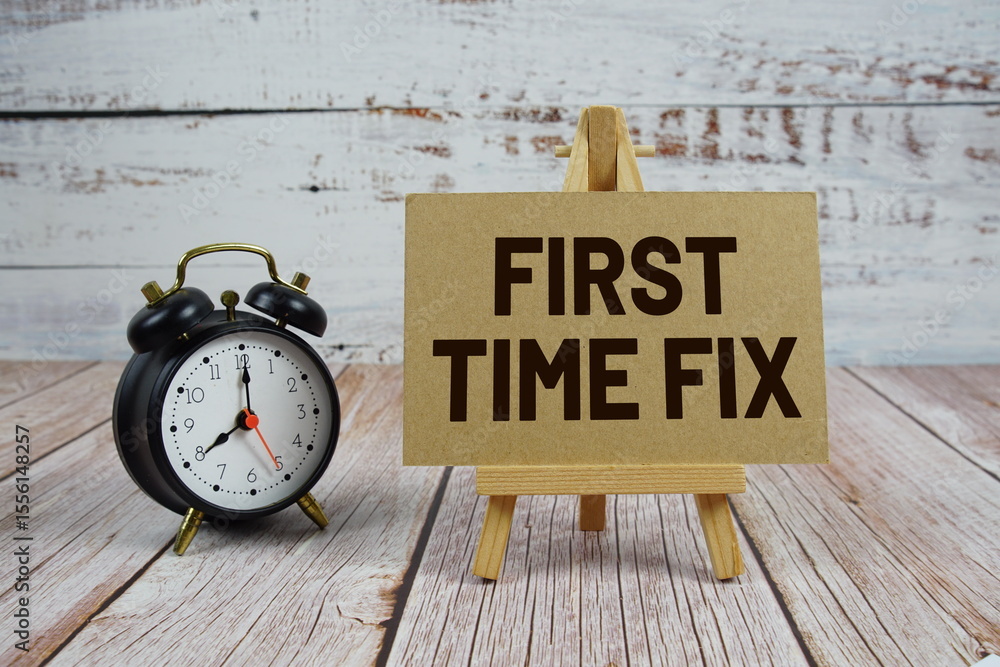 Poster first time fix text with easel and alarm clock on wooden background