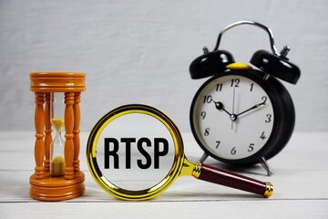 RTSP abbreviation of Real Time Streaming Protocol text with alarm clock on wooden background