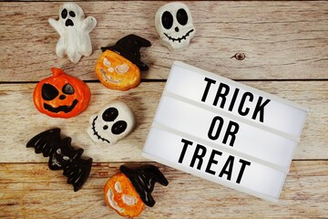 Trick or Treat text with element decorations on orange background