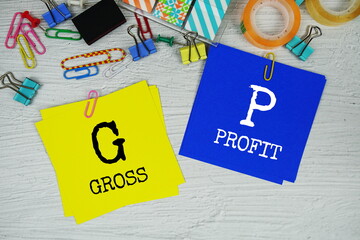 GP - Gross Profit text on stick note with stationery on concrete background