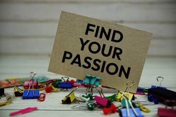 Find Your Passion text on paper card with stationary on wooden background