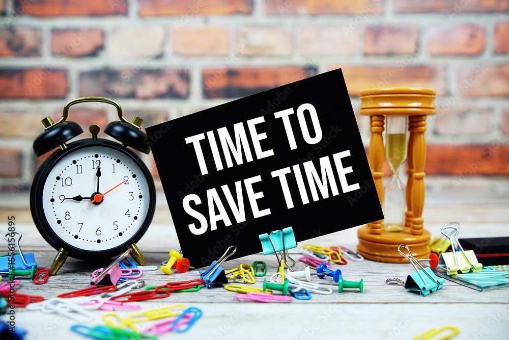 Poster time to save time text on paper card with alarm clock and stationary on wooden background