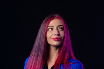 Woman in futuristic blue bodysuit with long pink hair