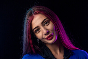 Woman in futuristic blue bodysuit with long pink hair