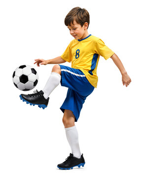 Fototapeta Young boy soccer player in yellow jersey doing a ball control on isolated background