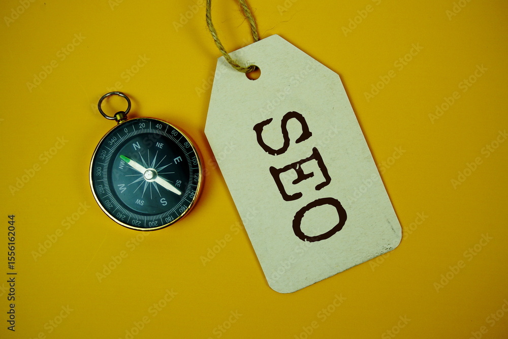 Fototapete seo search engine optimization text on price tag with compass on cork board background