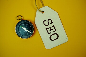 SEO Search Engine Optimization text on price tag with compass on cork board background