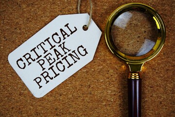 Critical Peak Pricing text on price tag with magnifying glass on cork board background