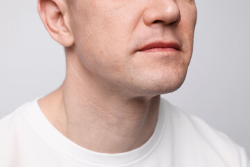 Obraz premium Clean shaven man on light background, closeup