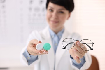 Portrait of professional ophthalmologist with glasses and contact lenses in clinic, selective focus