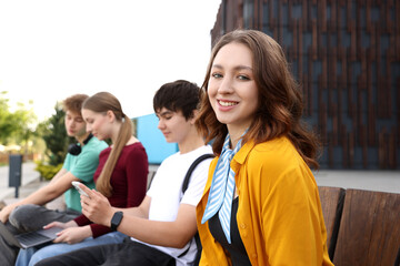 Teenagers spending time together outdoors, selective focus