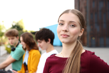 Fototapeta na wymiar Teenagers spending time together outdoors, selective focus
