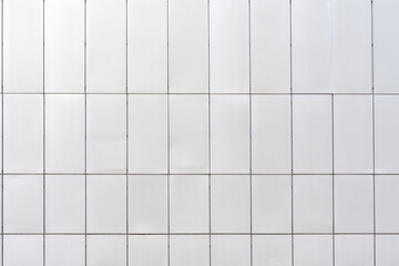 Facade cladding with metal panels of a building. This facade lives from imperfections. One gap is definitely too small, and there are dents in the panels.