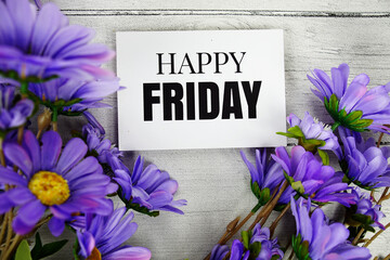 Happy Friday text with flowers decoration on wooden background
