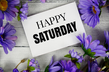 Happy Sunday text with flowers decoration on wooden background