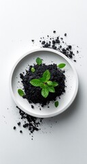 Black powder on white plate, small green plant sprouts