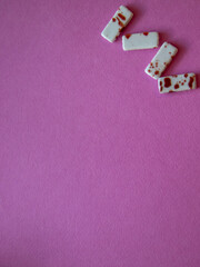 Furniture, beads for diy A vibrant pink surface with scattered dominoes, perfect for a game night...