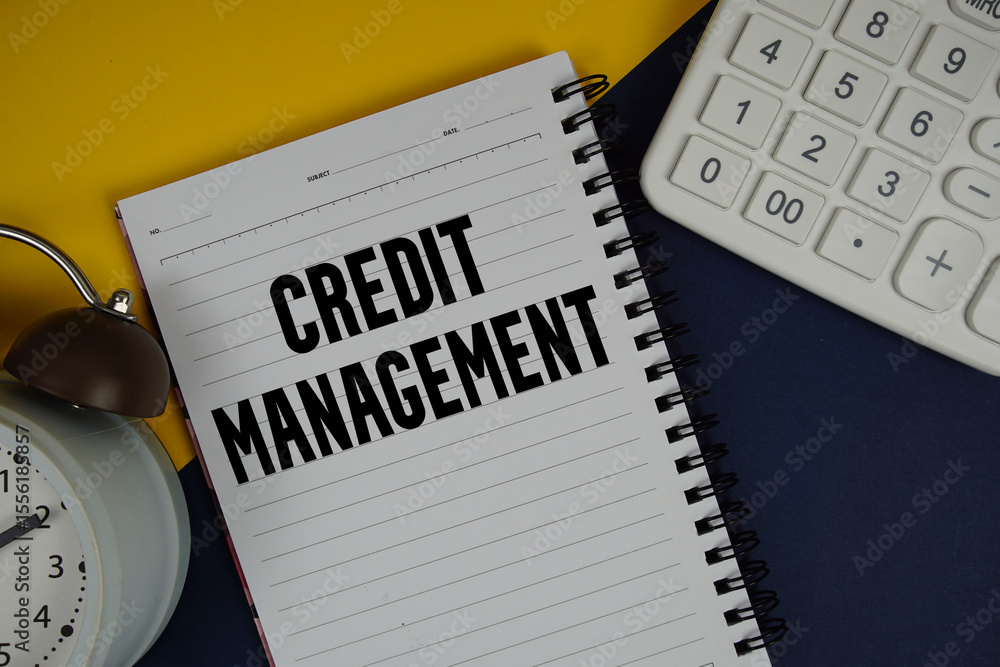 Poster credit management text written on notepad with calculator and alarm clock on navy blue background