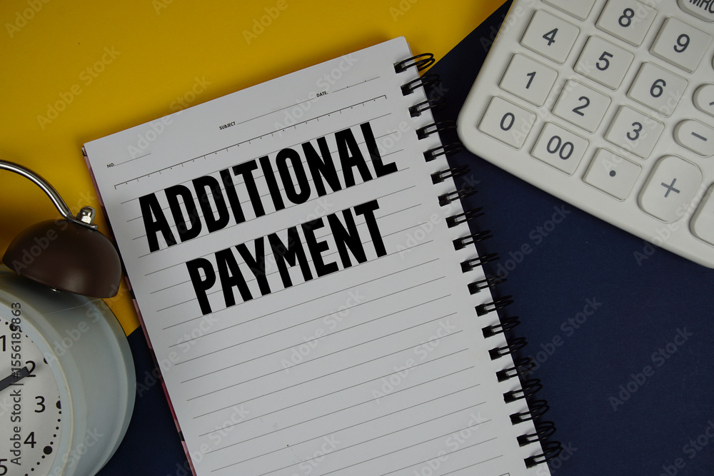 Aufkleber additional payment text written on notepad with calculator and alarm clock on navy blue background