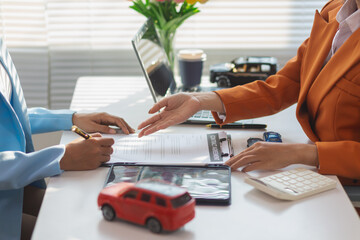 car dealer handing over keys female customer after successfully signing car sales contract. Concept...