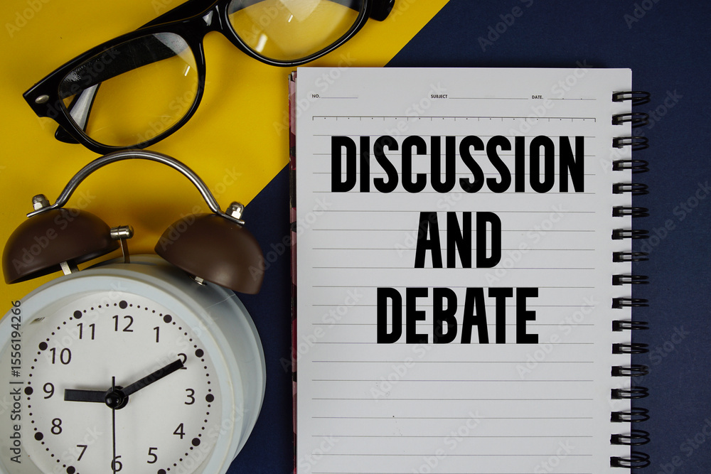 Poster discussion and debate text written on notepad with alarm clock on blue background