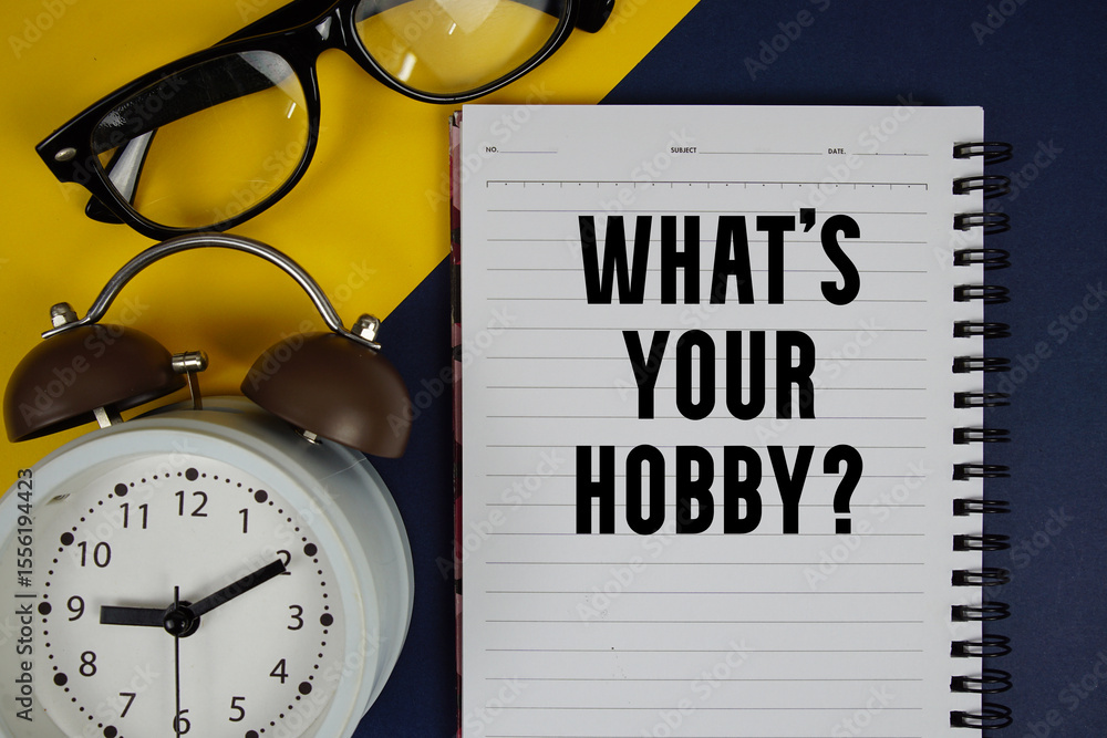 Poster what's your hobby? text written on notepad with alarm clock on yellow and navy blue background