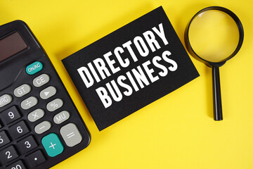 Directory Business text with magnifying glass anc calculator on yellow background