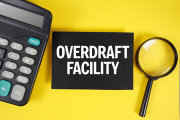 Overdraft Facility text with magnifying glass anc calculator on yellow background