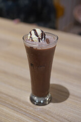 Decadent Chocolate Milkshake Topped with Vanilla Ice Cream and Syrup
