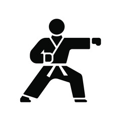 Karate fighter in a black gi performing a punch in a fighting stance