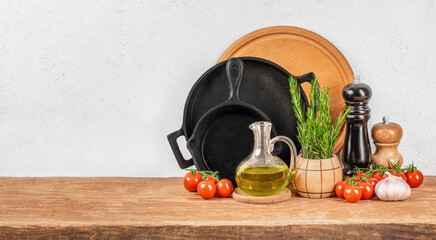 rustic kitchen counter scene with cast iron pans, fresh cherry tomatoes, olive oil, herbs, and...