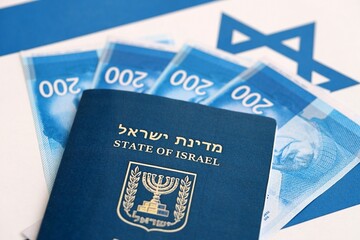 Israel New Shekels banknotes and passport on flag. The current Israel money bills and pass
