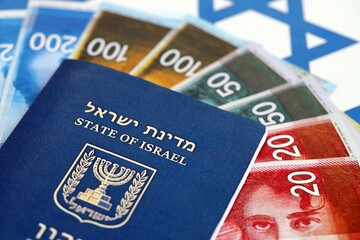 Israel New Shekels banknotes and passport on flag. The current Israel money bills and pass