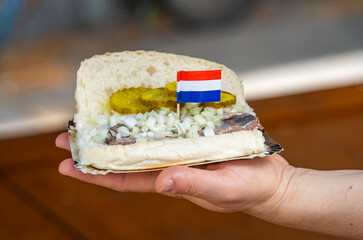 Herring sandwich, known in the netherlands as Broodje Haring, typical dutch snack with herring, pickles and onion