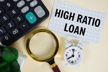 High Ratio Loan text with alarm clock, magnifying glass anc calculator on yellow background