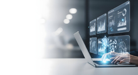Person using laptop with digital interface showing charts and graphs. Futuristic technology concept.