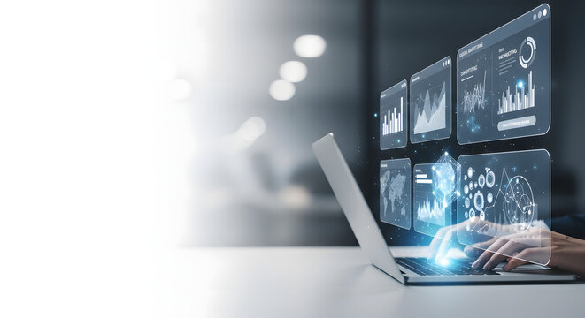 Person using laptop with digital interface showing charts and graphs. Futuristic technology concept.