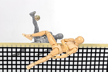 Attacker figurine performs dynamic half somersault spike and blocking in sepak takraw.