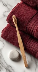 A wooden toothbrush, bath towels, and soap