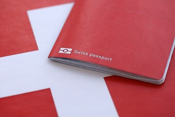 Swiss passport on flag. The current Swiss pass on flag close up