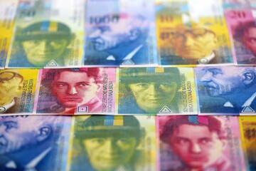 Swiss franc banknotes. The current francs money bills lies on table in big amount close up