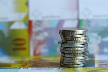 Swiss franc banknotes and coins. The current francs money bills and coins lies in big amount