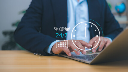 Businessman showing a 24-hour and 7-day icon, symbolizing 24/7 service, online payments, shopping, continuous transactions, and always-on cloud-based business operations for modern digital services.