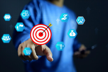 Target concept with a man pointing on dartboard represent to focus on business activity and...